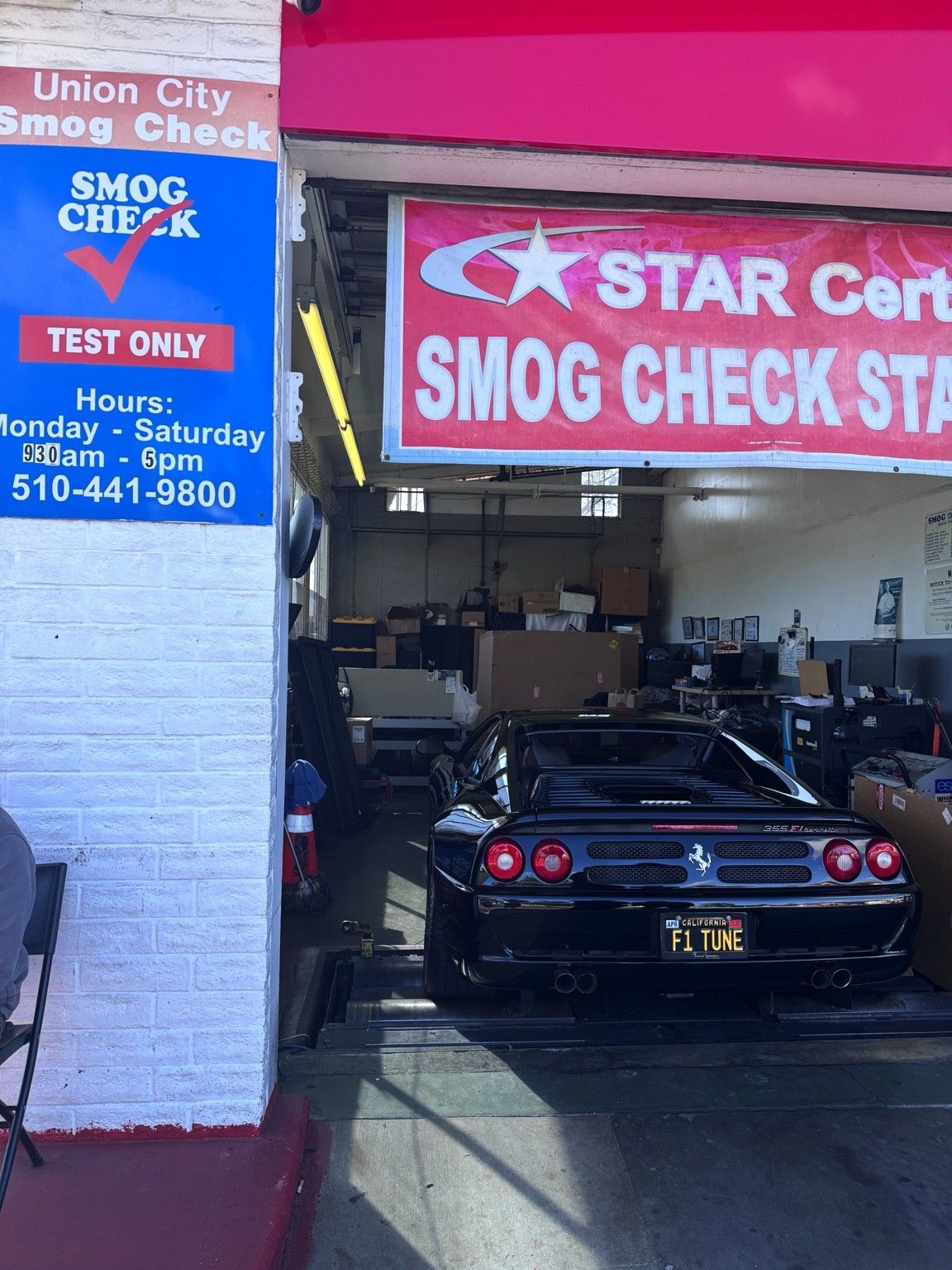 Black Ferrari F355 inside the Union City Smog Check test bay